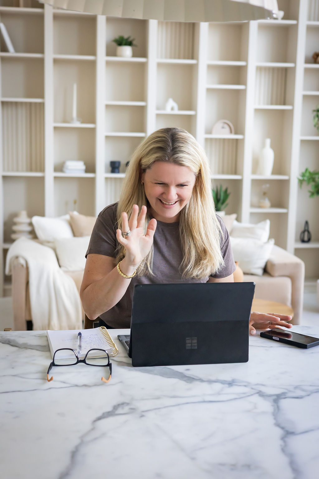 Sarah waving during a video call